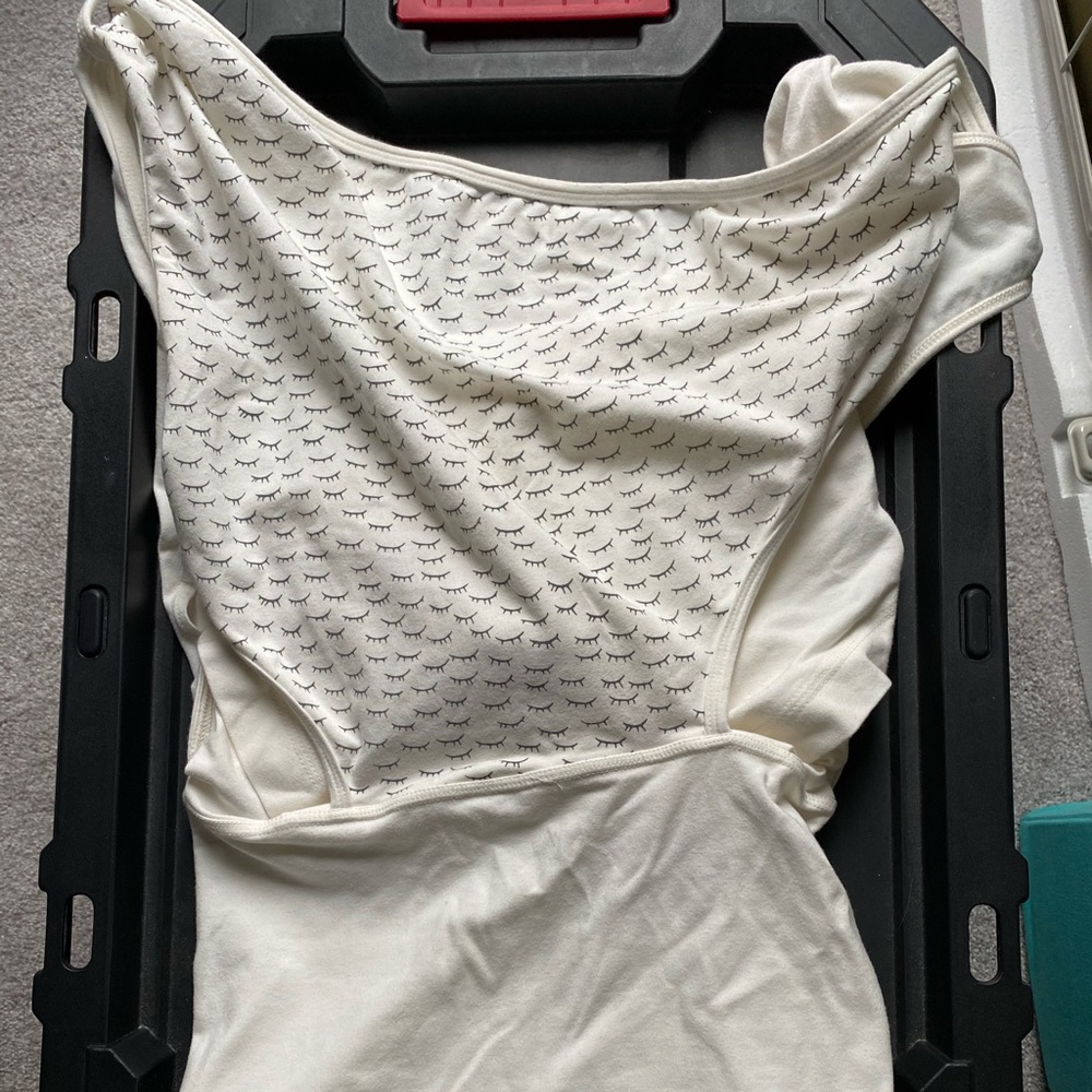 Nesting days baby wearing shirt